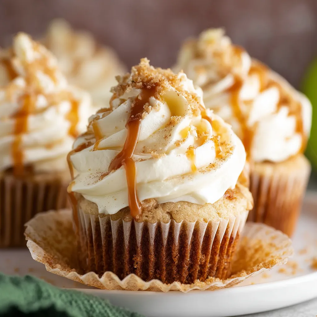 Caramel apple cupcake with frosting and apple slice. Delicious fall dessert.