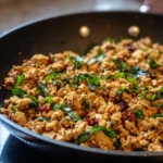 Ground chicken skillet with colorful bell peppers and onions.