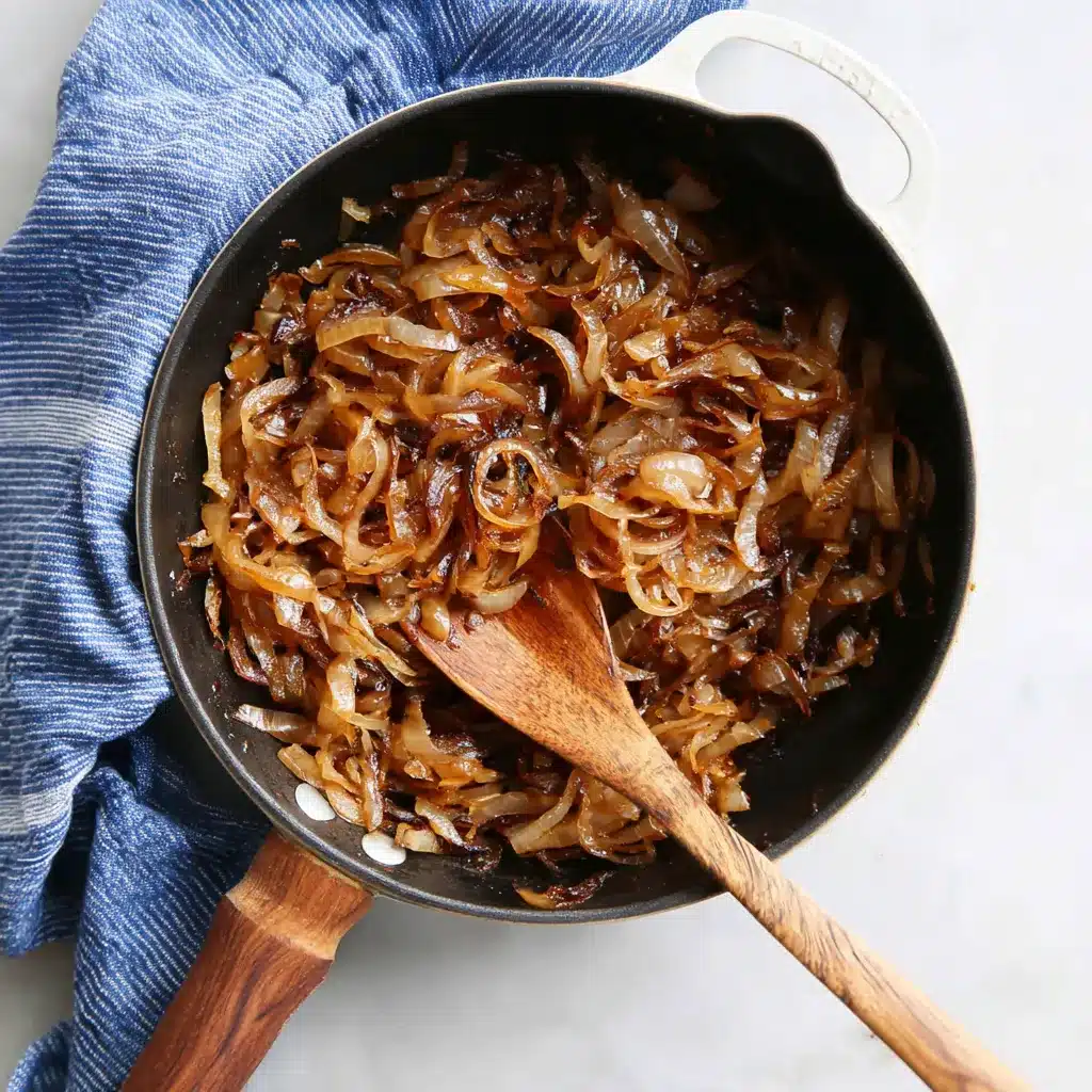 Close-up showcases perfectly caramelized onions, glistening with rich color and promising a melt-in-your-mouth flavor bomb for this delicious recipe.