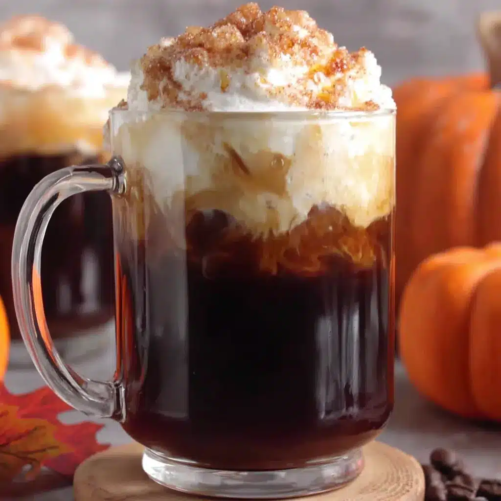 Irresistible pumpkin cold foam cascades over a glass, creating a creamy and cozy fall delight perfect for adding a seasonal twist to your favorite iced beverage.