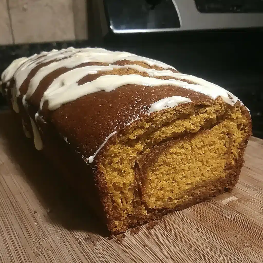 Close-up of a freshly baked loaf of irresistible swirled pumpkin cream cheese bread showing its soft texture and delicious cream cheese filling.