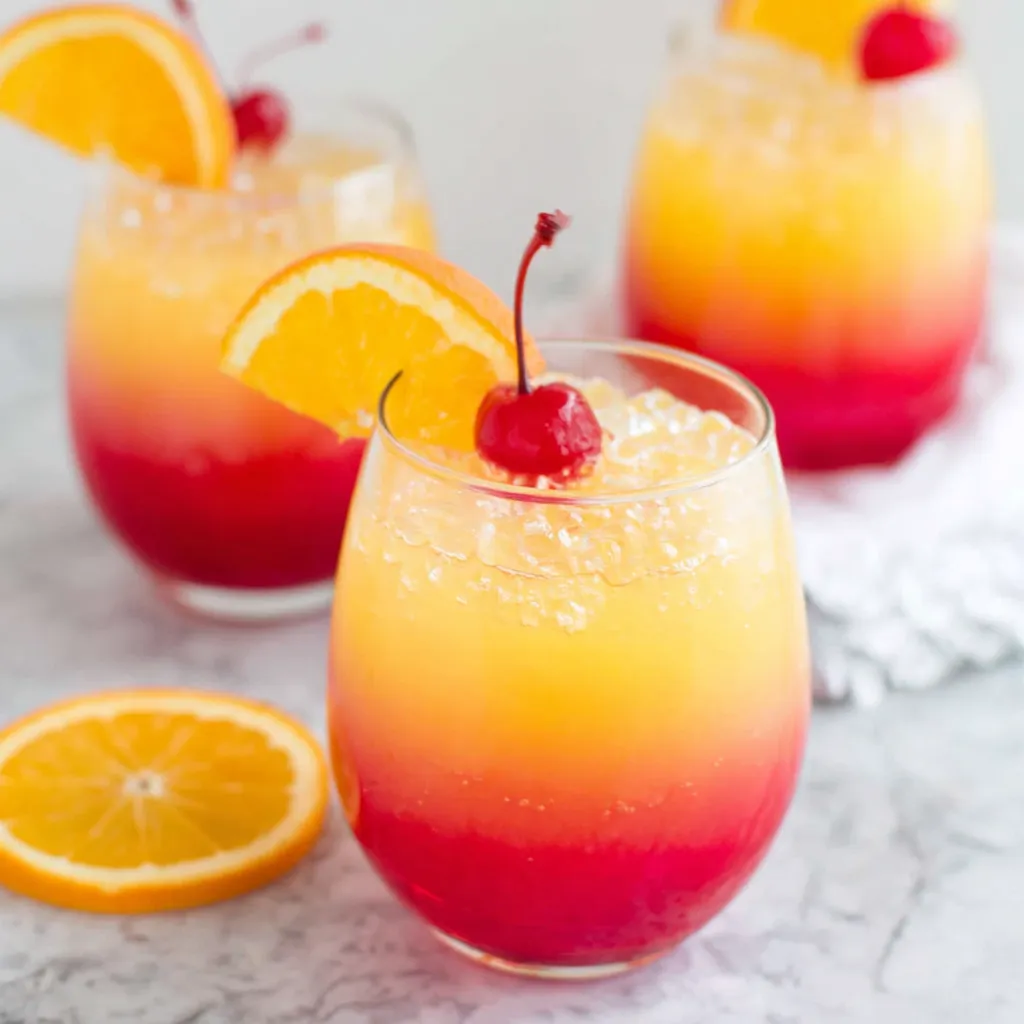Sunrise mocktail in a glass showcasing tropical vibes for a refreshing non-alcoholic drink option.