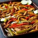 Sizzling sheet pan chicken fajitas with colorful bell peppers and onions, garnished with fresh cilantro and lime wedges, showcasing a vibrant and easy weeknight dinner recipe that promises maximum flavor with minimal cleanup.