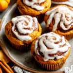 Easy pumpkin cinnamon roll muffins are displayed as a delicious and festive fall treat, perfect for a quick breakfast or dessert.