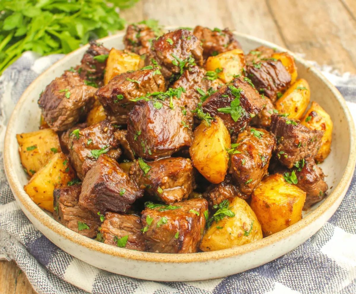 Slow Cooker Garlic Butter Beef & Potatoes Close-up view of tender Slow Cooker Garlic Butter Beef Bites With Potatoes, showcasing the rich sauce and perfectly cooked ingredients.