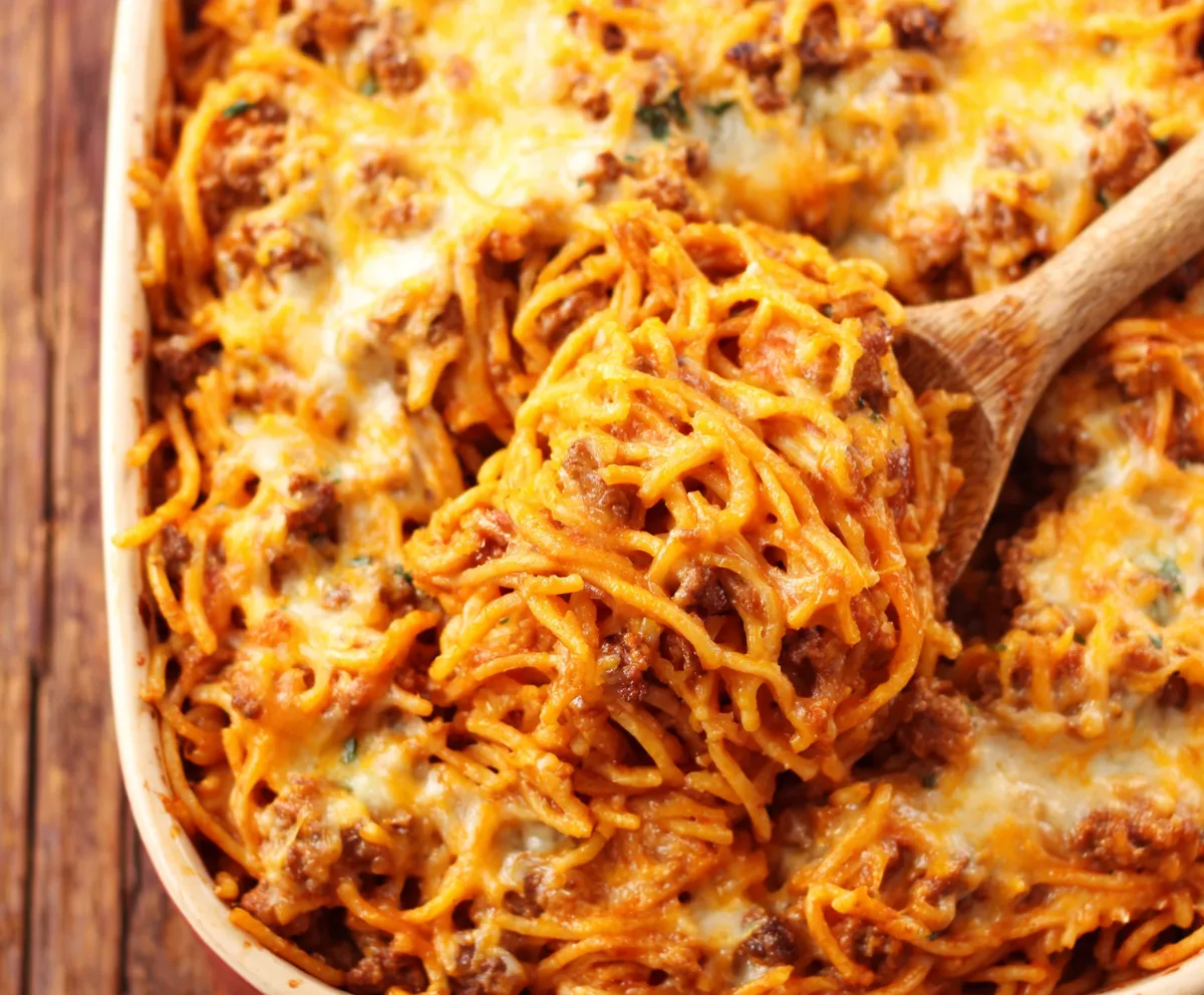 Southern Spaghetti Bake Recipe Close-up shot of a freshly baked Southern Spaghetti Bake with melted cheese and a golden-brown crust.