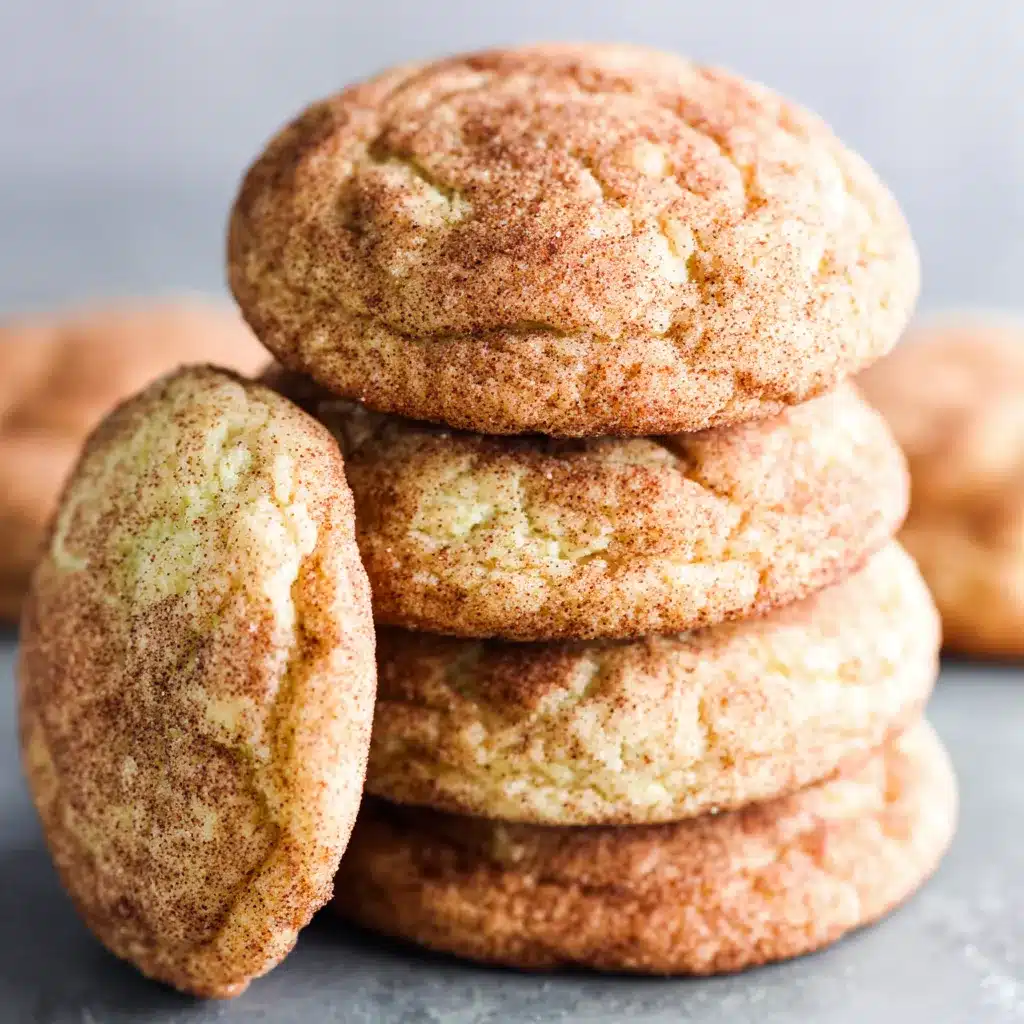 Soft & Chewy Snickerdoodle Cookies Close-up view of freshly baked Snickerdoodles, showcasing their characteristic cracks and cinnamon-sugar coating.